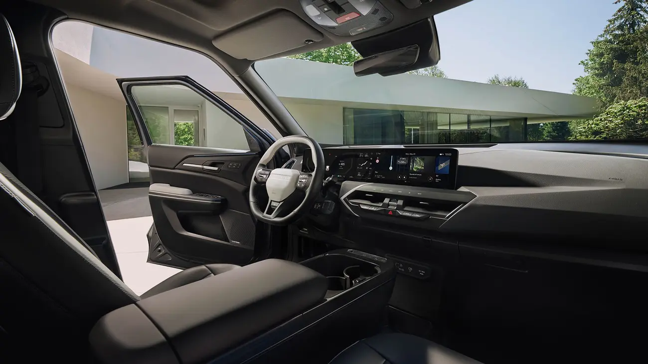 Kia EV5 interior with the two 12.3-inch screens and physical climate controls