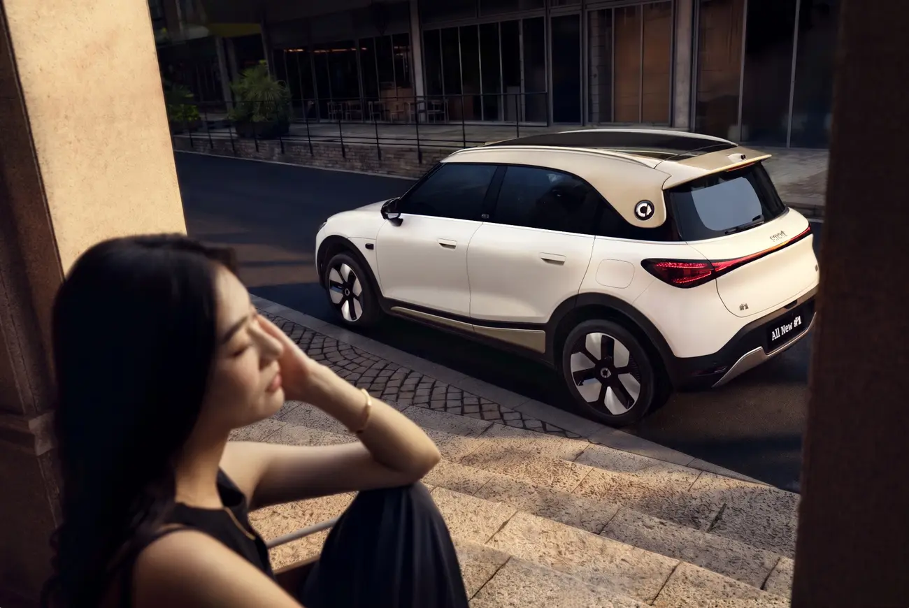 Smart #1 facelift seen from the rear three-quarter angle, showing the redesigned spoiler