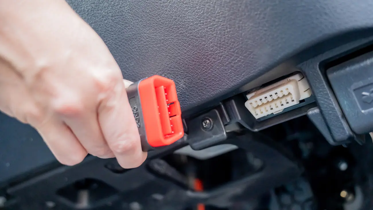 OBD-II adapter plugged into a car's diagnostic port