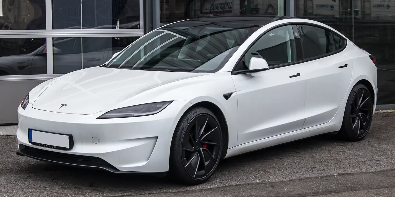 Tesla Model 3 RWD Highland shown in front three-quarter view in an outdoor setting