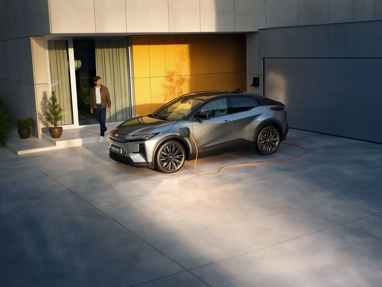 Toyota C-HR+ plugged into a DC fast charger with the CCS cable connected